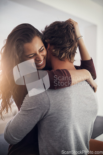 Image of Love, passion and a couple laughing in the kitchen of their home together in the morning for romance. Funny, intimate or sexy with a man and woman in their house for romantic intimacy or bonding