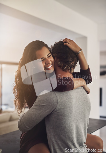 Image of Happy young couple hugging in home for love, romance and caring bond together with excited partner. Woman, man and hug of lovers in relationship, dating and smile for happiness, care and loyalty