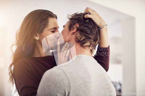 Image of Face of happy woman, man and kiss with love in apartment for romance, intimacy and special moment together. Young couple kissing in home for romantic relationship, happiness and passionate partner
