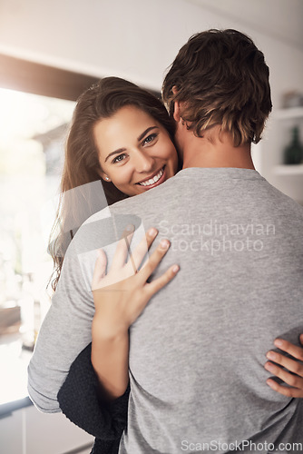 Image of Portrait of happy woman, man and hug of love, care and quality time together for commitment to relationship at home. Young couple, smile and hugging for romance, trust and relax with partner in house