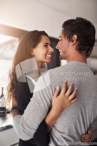 Image of Happy woman, man and hug in apartment for love, care and quality time together with commitment to relationship. Young couple, hugging and smile for anniversary of lovers, relax and loyalty to partner