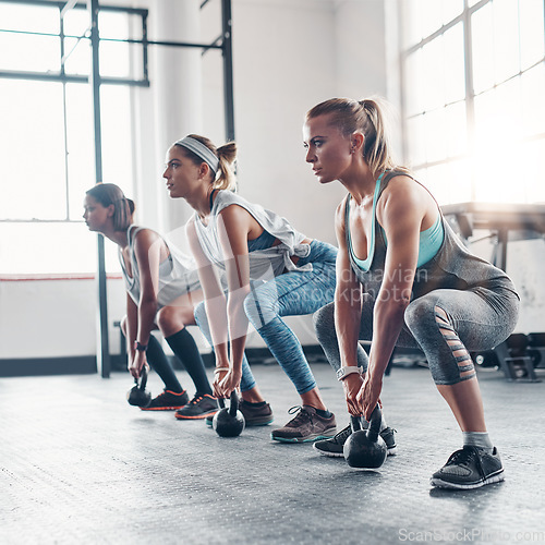Image of Group, exercise and women training, kettlebell and workout goal with wellness, healthy lifestyle and sports. Female athletes, girls and friends with gym equipment, balance and stretching for cardio