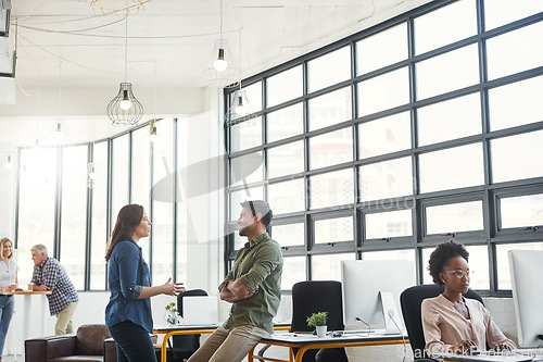 Image of Conversation, man and woman in modern office with smile and creative advice at startup agency together. Talking, desk and happy team leader coaching designer at work with help, support and opinion.