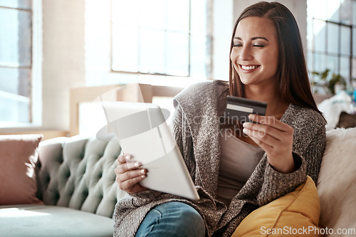 Image of Happiness, online shopping and credit card, woman on sofa and mobile app on tablet, internet banking in home. Technology, cashback payment and happy girl on couch on retail website or digital shop.