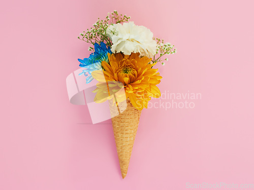 Image of Flowers, cone and ice cream in a studio for decoration, creativity or art with fresh and colorful bouquet. Creative, still life and blossom floral plants in a dessert isolated by pink background.