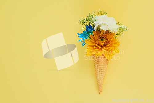 Image of Flowers ice cream in a cone in studio for creative, art or decoration with fresh and colorful bouquet. Creativity, still life and floral plants in a dessert isolated by yellow background with mockup.