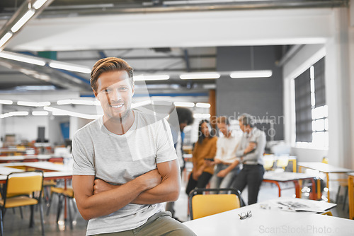 Image of Man, startup and modern office in portrait, arms crossed or smile with excited face for career. Young businessman, creative professional person or sitting on table in workplace with web design job
