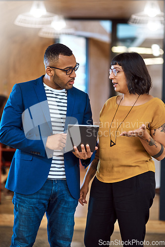 Image of Tablet, team or business people talking in office with ideas, internet and diversity. A professional man and woman together for a creative project using online app for discussion, strategy or advice