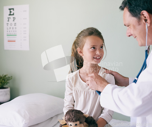 Image of Healthcare, kids and a girl at a man pediatrician for an appointment or checkup in the hospital. Medical, stethoscope and heart with an adorable little female child sitting on a bed in the clinic