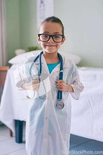 Image of Girl kid, portrait and playing doctor with smile, glasses and stethoscope in home, hospital or clinic. Female child, play medic and happy with excited face, learning and game for development in house