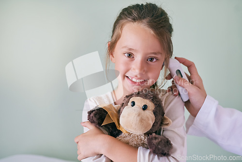 Image of Healthcare, portrait and a girl at the pediatrician for an ear checkup or appointment in the hospital. Medical, temperature or thermometer with a happy and adorable female child at the health clinic