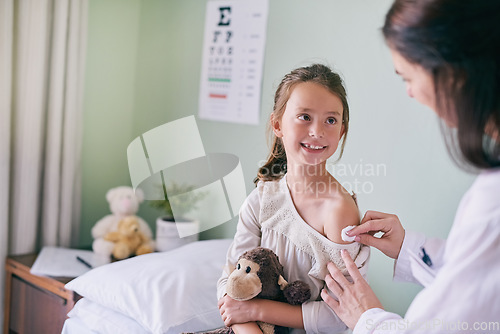 Image of Healthcare, children and a girl at the pediatrician for an appointment or checkup in the hospital. Medical, covid and vaccine with an adorable little female child sitting on a bed in the clinic