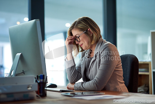Image of Headache, stress and business woman in office, tired or fatigue while working late at night on computer. Burnout, deadline and female worker with depression, anxiety or brain fog, sick or exhausted.