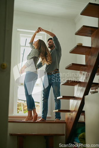 Image of Love, couple and dancing in home, bonding and having fun together for romance. Dance, happy and man and woman, funny and care, affection and enjoying quality time by stairs to relax on anniversary.