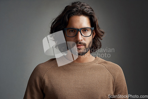 Image of Portrait, glasses and serious man in studio isolated on a gray background. Face, nerd and handsome male person from Australia with spectacles, eyewear or frames for fashion, stylish and aesthetic.