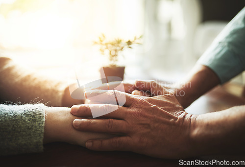 Image of Holding hands, senior couple and retirement support with kindness and marriage. Home, sofa and elderly people with empathy, hope and trust with solidarity for finance problem in a lounge together