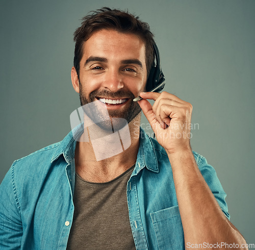 Image of Happy man, headphones and portrait smile of call center consultant against a grey studio background. Face of friendly male consulting agent smiling with headset mic in contact us for online advice