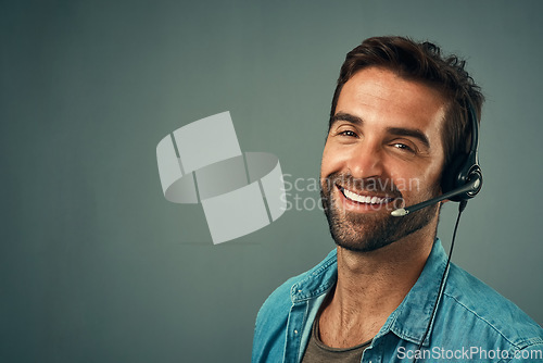 Image of Happy man, call center and portrait of consultant on mockup space against a grey studio background. Face of friendly male consulting agent with smile and headset in contact us, help or online advice