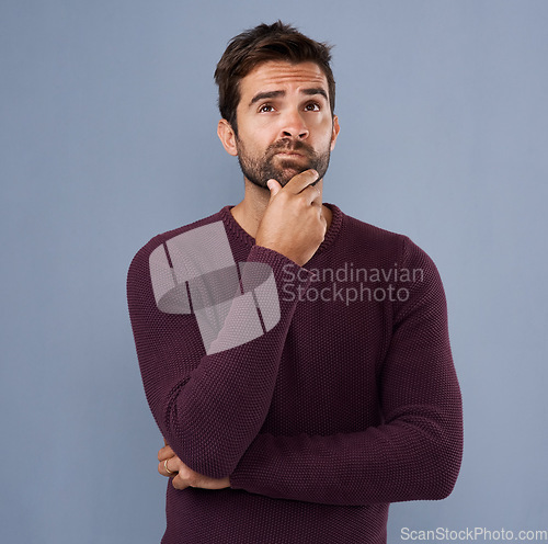 Image of Thinking, confused and face of man in studio with unsure, uncertain and thoughtful on gray background. Doubtful, mockup space and isolated male person skeptical for decision, choice and question