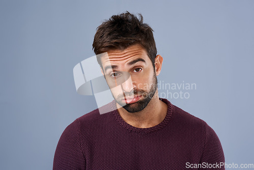 Image of Bored, portrait and annoyed man in studio tired and moody against a grey background space. Fatigue, face and man with negative attitude posing with exhasuted expression while standing isolated