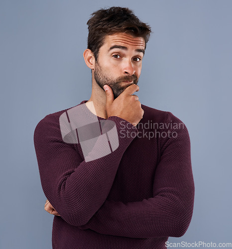 Image of Idea, thinking and portrait of man in studio with unsure, wonder and thoughtful on blue background. Doubt, mockup space and face of isolated male person skeptical for decision, choice and question