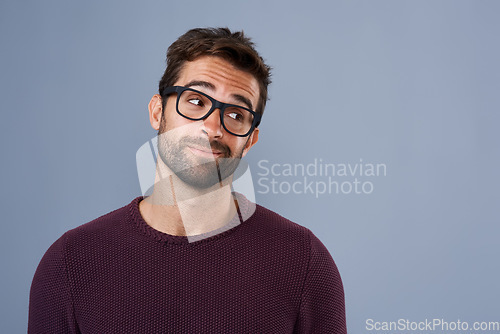 Image of Mockup, thinking and face of man in studio with announcement, information and news space. Wondering, thoughtful mock up and male person looking for decision, choice and question on gray background