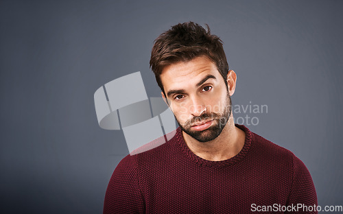 Image of Bored, portrait and annoyed man in studio unhappy and moody against a grey background space. Sad face of depression and man with negative attitude posing with isolated, whatever or tired expression