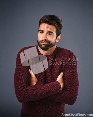 Image of Doubt, shrug and portrait of man in studio unsure against a grey background space. Confused, face and shrugging male with dont know expression, puzzled and pensive with choice and decision isolated