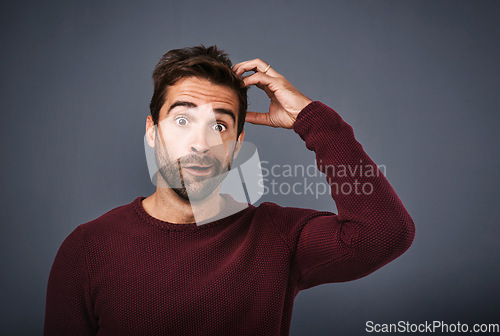 Image of Confused, worry and portrait of man in studio with doubt, scratch head and thoughtful on gray background. Thinking, mockup space and funny face of male person wonder for decision, choice and question