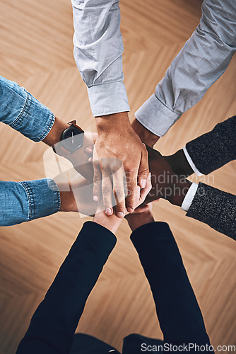 Image of Teamwork, partnership or hands of business people in support for faith, vision or strategy in office. Above, diversity or employees in group collaboration with hope or mission for goals together