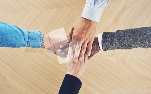 Image of Diversity, above or hands of business people in support for love, teamwork or community strategy in office. Closeup, hand or employees in group collaboration with hope or mission for goals together