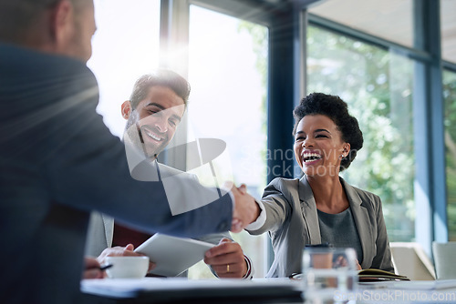 Image of Meeting, partnership and business people shaking hands in the office for a deal, collaboration or onboarding. Diversity, professional and employees with handshake for agreement, welcome or greeting.