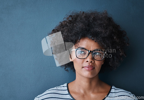 Image of Optometry, eye care and woman with glasses in studio with thinking, pensive or idea face expression. Optical wellness, healthcare and African female model with spectacles isolated by blue background.