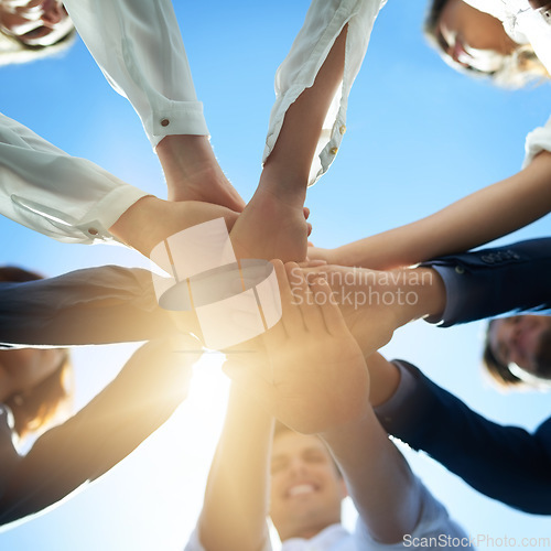 Image of Hands together, trust and business people in team with low angle, support and solidarity with professional community. Diversity, collaboration and corporate group in meeting with goals and commitment