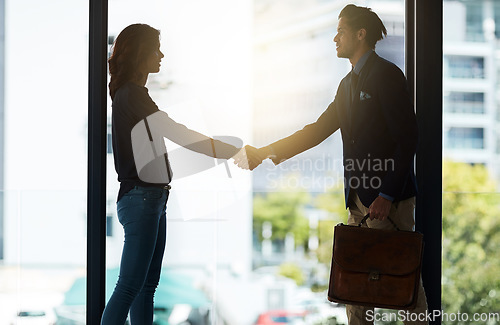 Image of Silhouette, handshake and business people in office for agreement, planning and teamwork. Corporate workplace, collaboration and man and woman shaking hands for partnership, thank you and welcome