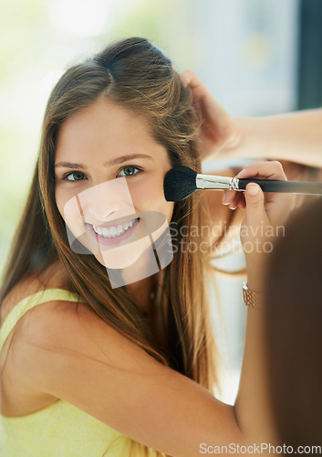 Image of Portrait, makeup and blusher with a woman in the bathroom, using a mirror to apply cosmetics to her face. Reflection, brush and morning beauty routine with a happy young female person applying blush