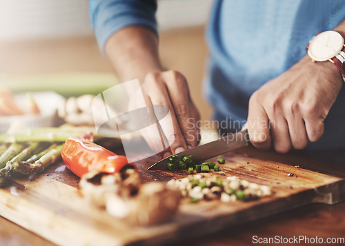 Image of Cooking, chopping board and hands of man in kitchen for food, wellness and nutrition. Health, diet and dinner with closeup of male chef cutting vegetables with knife at home for lunch, vegan or salad