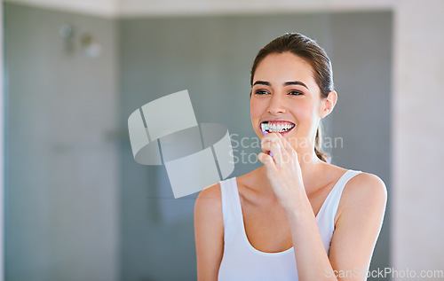 Image of Toothbrush, toothpaste and woman brushing teeth in bathroom for health, happiness and wellness in morning. Girl, cleaning mouth for dental care and oral hygiene or smile in home with mockup space