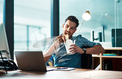 Image of Business, man and eating noodles in office at desk, laptop and working in startup company at night. Hungry young male employee, fast food and late dinner at computer technology in agency at evening