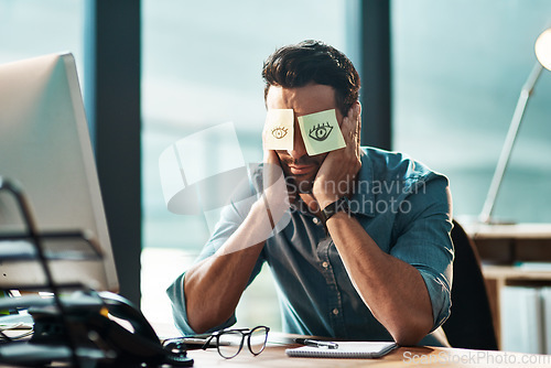 Image of Tired, sleeping and a man with sticky note on face during overtime, late work and business at night. Fatigue, burnout and a businessman with paper to cover eyes during sleep at a desk for a deadline