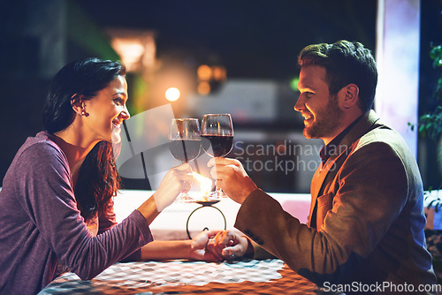 Image of Cheers, wine and couple on date in restaurant, romance and happiness in celebration of love and drinks. Romantic honeymoon night, man and woman toast glasses in cafe, smile on dinner holiday travel.