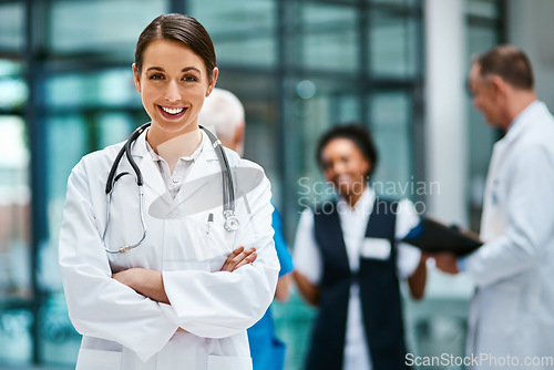 Image of Healthcare, happiness and portrait of woman doctor with confident smile in hospital for leadership in medicine. Health care career, wellness and medical professional with mockup in lobby of clinic.