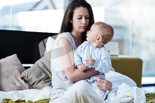 Image of Mother, baby and depression in the bedroom is sad and need help with mental health and raise children. Newborn, parent and postpartum is frustrated in bed with anxiety and stress in family home.