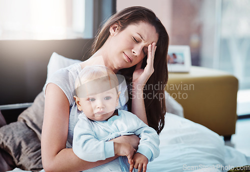 Image of Stress, headache and a a mother with her baby in a bedroom of their home together in the morning. Children, family and burnout with a tired mama sitting on a bed with an infant son as a single parent