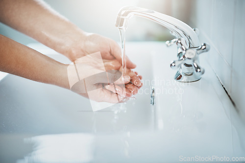 Image of Woman, clean and washing hand with water at home for wellness, cleaning and hygiene in sink. Wash, hands and skincare to remove bacteria for self care, disinfection, health and safety at a house.