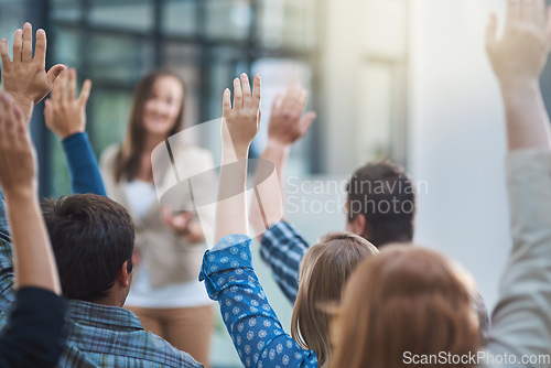 Image of Woman speaker at conference, group of people with hands up for question or answer at training presentation or meeting. Feedback, opinion and ideas, men and women at seminar, hand in air and questions