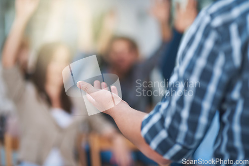 Image of Speaker at seminar, audience with hands up for questions and answers at training presentation or meeting. Feedback, opinion and ideas, group of people at conference, hand in air for question or input