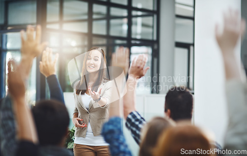 Image of Woman at seminar, audience with hands up for questions and answers at training presentation or meeting. Feedback, opinion and ideas, group of people at conference with hand in air, coaching and faq.