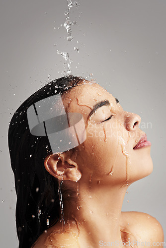 Image of Shower, water and face profile of woman in studio on gray background for wellness, cleaning and satisfaction. Skincare, bathroom and female person with beauty for washing hair, hygiene and cleansing