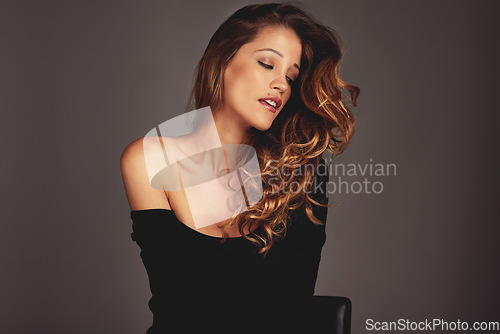 Image of Woman, face and beauty with hair care in studio for salon shine, fashion inspiration or cosmetics. Aesthetic female model person with facial skin glow, makeup and seductive style on a grey background